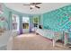 Bright bedroom with a mermaid-themed wall, three windows, and a ceiling fan at 3412 Trapnell Ridge Dr, Plant City, FL 33567
