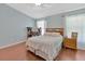 Bright bedroom with ceiling fan, wood floors, and light blue walls at 3412 Trapnell Ridge Dr, Plant City, FL 33567