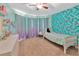 Sunlit bedroom with mermaid wall, birdcage, and dresser creates inviting space at 3412 Trapnell Ridge Dr, Plant City, FL 33567