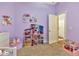 Charming bedroom with a dollhouse, and a doorway to another room at 3412 Trapnell Ridge Dr, Plant City, FL 33567