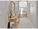 Inviting entryway with tiled floor, a decorative table with mirror, and a view into the kitchen and living area at 3412 Trapnell Ridge Dr, Plant City, FL 33567