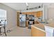 Functional kitchen with stainless steel appliances, wood cabinets, and a cozy breakfast nook at 3412 Trapnell Ridge Dr, Plant City, FL 33567