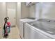 Functional laundry room with a washer, dryer, and tile flooring at 3412 Trapnell Ridge Dr, Plant City, FL 33567