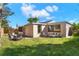 Beautiful backyard featuring a cozy patio with outdoor seating, perfect for relaxing and entertaining at 3455 Overland Dr, Holiday, FL 34691