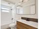 Modern bathroom with a shower-tub, vanity with solid surface top and dark bronze faucet at 3455 Overland Dr, Holiday, FL 34691