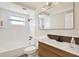 Modern bathroom with a shower-tub, vanity with solid surface top, and updated fixtures at 3455 Overland Dr, Holiday, FL 34691