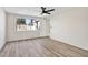 Bright bedroom featuring a large window and light-colored, wood-look floors at 3455 Overland Dr, Holiday, FL 34691