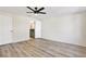 Light-filled bedroom with wood-look floors and an ensuite bathroom featuring green cabinetry at 3455 Overland Dr, Holiday, FL 34691
