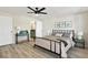 Bedroom featuring a bed with neutral linens, wood-look floors, and ensuite bathroom at 3455 Overland Dr, Holiday, FL 34691