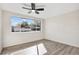 Bedroom featuring wood-look floors, and a large window bringing in natural light at 3455 Overland Dr, Holiday, FL 34691