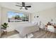 Bedroom featuring wood-look floors, a large window, and a workspace with a desk at 3455 Overland Dr, Holiday, FL 34691