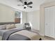 Bedroom featuring wood-look floors, a ceiling fan with light, window, chair, and closet at 3455 Overland Dr, Holiday, FL 34691