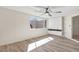 Sunlit bedroom with built-in closets, wood-look floors, and a view to the outside at 3455 Overland Dr, Holiday, FL 34691