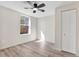 Bedroom featuring wood-look floors, a ceiling fan with light, a window, and closet at 3455 Overland Dr, Holiday, FL 34691