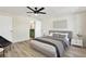 Bedroom features wood-look flooring, ceiling fan, and ensuite bathroom with green cabinetry visible at 3455 Overland Dr, Holiday, FL 34691