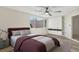 Bright bedroom featuring a ceiling fan, light wood floors, closet, and large window at 3455 Overland Dr, Holiday, FL 34691