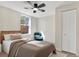Bedroom featuring wood-look floors, a ceiling fan with light, window, chair, and closet at 3455 Overland Dr, Holiday, FL 34691