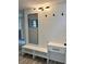 Bright entryway featuring a built-in bench with storage, a sleek mirror, and modern lighting at 3455 Overland Dr, Holiday, FL 34691