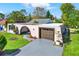 Charming single-story home with a gray driveway and a well-manicured front lawn at 3455 Overland Dr, Holiday, FL 34691