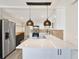 Modern kitchen with stainless steel appliances, a spacious island, and stylish pendant lighting at 3455 Overland Dr, Holiday, FL 34691