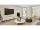 Bright living room features wood-look flooring, a white sofa, and a round coffee table with a woven rug at 3455 Overland Dr, Holiday, FL 34691