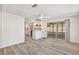 Open-concept living space with stylish flooring, seamless flow to the kitchen, and bright lighting at 3455 Overland Dr, Holiday, FL 34691