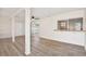 Bright living room with wood-look floors, white walls, a large window, and an open floorplan at 3455 Overland Dr, Holiday, FL 34691