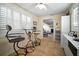 Eat-in breakfast nook features tile flooring and black wrought iron high-top table set by large bright window at 3617 Horatio St, Tampa, FL 33609