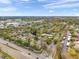 Expansive aerial view of a community with lush landscaping, a pool, and waterfront access on a sunny day at 3970 La Costa Ln, Largo, FL 33771