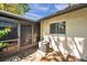 Back patio view shows screen door, plants, and AC unit at 3970 La Costa Ln, Largo, FL 33771