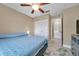 Relaxing bedroom with a ceiling fan, comfortable bed, and plenty of closet space at 3970 La Costa Ln, Largo, FL 33771