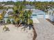Charming light blue single-story home with palm trees, new driveway, and a one-car garage at 427 79Th Ave, St Pete Beach, FL 33706