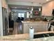 Open-concept kitchen with island, stainless steel appliances, and view into the dining and living area at 427 79Th Ave, St Pete Beach, FL 33706