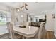 Bright dining area with decorative chandelier, wooden table and direct view to the living room at 4415 Black Fox Dr, New Port Richey, FL 34653