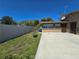 Well-maintained backyard with a white fence, grassy area, and concrete patio at 514 Brandon Ave, Clearwater, FL 33765