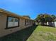A backyard view showcasing the siding, landscaping, and well-maintained lawn at 514 Brandon Ave, Clearwater, FL 33765