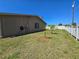 A view of the home's backyard with green grass and landscaping along the fence at 514 Brandon Ave, Clearwater, FL 33765
