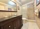 Bathroom boasting a vanity, toilet, and a glass door shower with tile surround at 514 Brandon Ave, Clearwater, FL 33765