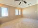 A cozy bedroom featuring tiled floors, two windows, and neutral walls at 514 Brandon Ave, Clearwater, FL 33765