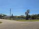 Residential street view featuring a well-maintained property with fencing and mature trees at 514 Brandon Ave, Clearwater, FL 33765