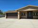 The exterior showcasing the home's entrance, two-car garage, and tidy landscaping at 514 Brandon Ave, Clearwater, FL 33765