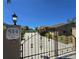 Secured property featuring an iron gate, long driveway and a glimpse of the backyard swimming pool at 514 Brandon Ave, Clearwater, FL 33765