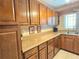 Kitchen counter featuring wood cabinetry and a solid surface countertop at 514 Brandon Ave, Clearwater, FL 33765