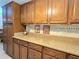 Kitchen counter featuring wood cabinetry and a solid surface countertop at 514 Brandon Ave, Clearwater, FL 33765