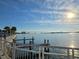 Scenic waterfront view with a pier, calming water, and the bright sunshine in the clear blue sky at 514 Brandon Ave, Clearwater, FL 33765