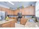 Well-lit kitchen featuring granite countertops, stainless steel appliances and tile backsplash at 5916 Tulip Flower Dr, Riverview, FL 33578