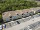 Aerial view of multi-Gathering home featuring ample parking, lush landscaping, and a well-maintained exterior at 6447 Cypressdale Dr # 202, Riverview, FL 33578