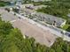 Community aerial view showcasing multiple units, parking, and surrounding trees providing a sense of privacy at 6447 Cypressdale Dr # 202, Riverview, FL 33578
