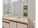 Bathroom features a large mirror and vanity with storage space at 6447 Cypressdale Dr # 202, Riverview, FL 33578