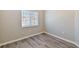 Bedroom featuring wood-look floors and a window with blinds at 6447 Cypressdale Dr # 202, Riverview, FL 33578